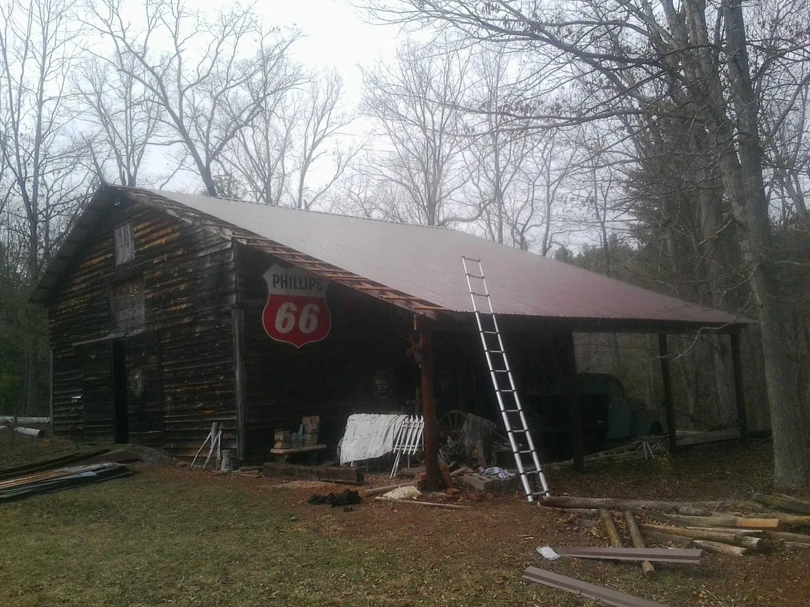 New metal roof on an open sided timber barn with a vintage sign in Zellwood